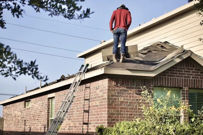 Professional roofer working on a residential roof in Monmouth Junction